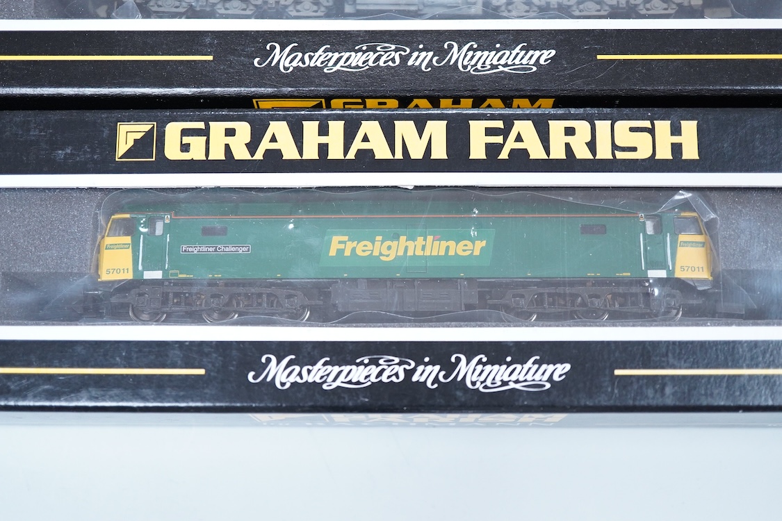 Three boxed Graham Farish N gauge railway diesel locomotives; an EWS class 56, 56105 (371300), a Load Haul class 56, Kellingley Colliery 56 074 (371301), and a Freightliner class 57, Freightliner Challenger 57011, (37122